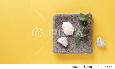 spa background with towel, eucalyptus branch and zen like stones. top view. copy space. banner spa background with towel, eucalyptus branch and zen like stones. top view. copy space. banner 99248652