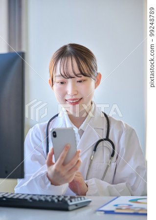 Young female doctor doing online medical treatment Young female doctor doing online medical treatment 99248789