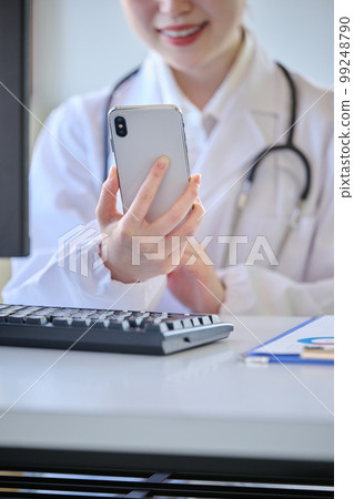 Young female doctor doing online medical treatment Young female doctor doing online medical treatment 99248790