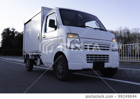 Light freight vehicles stopping on the shoulder of the road 99249044