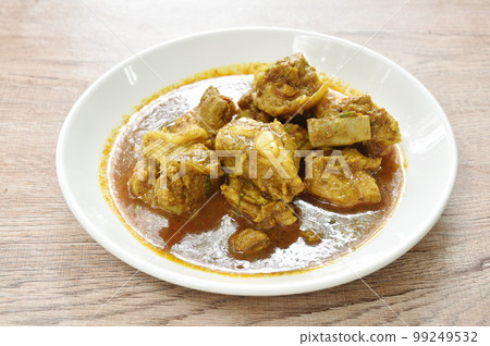 spicy boiled pork bone with curry and basil leaf on plate 99249532