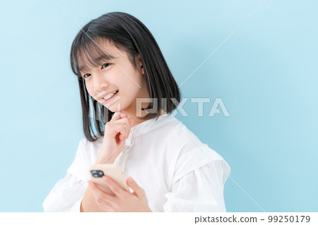 Girl worried smartphone 99250179