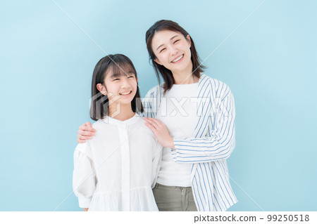 Good friends, mother and daughter, blue background 99250518