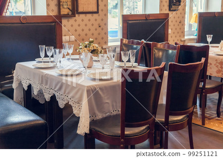 A set table in retro style in the restaurant. 99251121