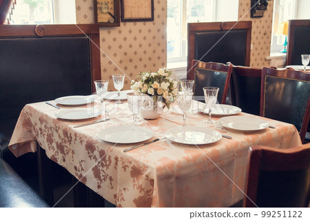 A set table in retro style in the restaurant. A set table in retro style in the restaurant. 99251122