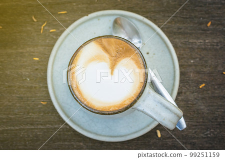 A cup of Latte coffee on wooden table. A cup of Latte coffee on wooden table. 99251159