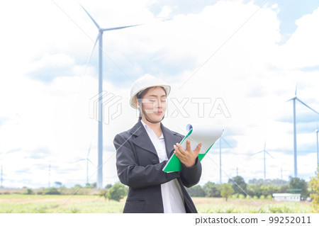 asian female and man Manager Engineer in Safety Helmet Checking With Tablet An Operation Of Solar Panel System At Solar Station in farm. 99252011