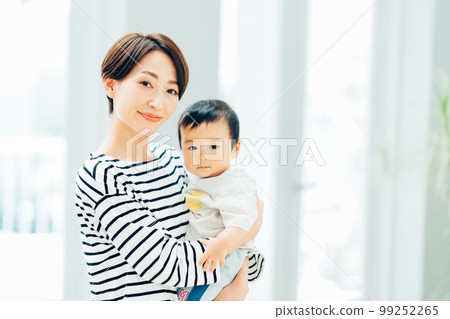 A mother holding a baby. A mother holding a baby. 99252265