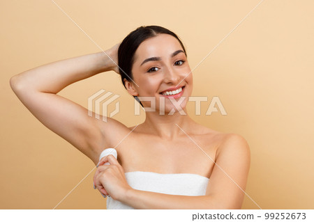 Personal Hygiene. Smiling Young Indian Woman Applying Stick Deodorant To Underarm Zone Personal Hygiene. Smiling Young Indian Woman Applying Stick Deodorant To Underarm Zone 99252673