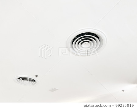 Ceiling mounted cassette type air conditioner and modern lamp light on white ceiling. duct air conditioner for home or office Ceiling mounted cassette type air conditioner and modern lamp light on white ceiling. duct air conditioner for home or office 99253019