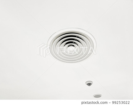 Ceiling mounted cassette type air conditioner and modern lamp light on white ceiling. duct air conditioner for home or office 99253022