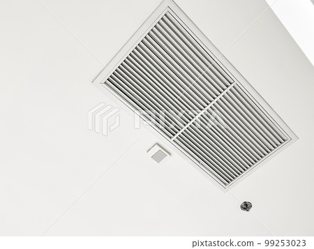 Ceiling mounted cassette type air conditioner and modern lamp light on white ceiling. duct air conditioner for home or office Ceiling mounted cassette type air conditioner and modern lamp light on white ceiling. duct air conditioner for home or office 99253023