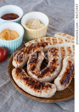 Grilled sausages with sauce and vegetable 99253447
