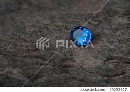 blue sapphire on black stone background blue sapphire on black stone background 99253657
