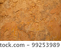 Old ochre yellow stone wall abstract background photo. 99253989