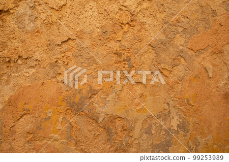 Old ochre yellow stone wall abstract background photo. Old ochre yellow stone wall abstract background photo. 99253989