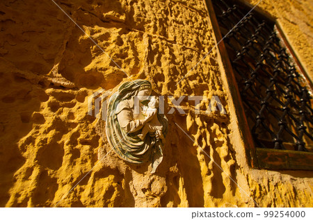 Traditional religious catholic bas-relief od Virgin Mary with baby Jesus near the building entrance in Mdina, Malta Traditional religious catholic bas-relief od Virgin Mary with baby Jesus near the building entrance in Mdina, Malta 99254000