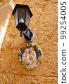 Traditional religious catholic bas-relief od Virgin Mary with baby Jesus near the building entrance in Mdina, Malta 99254005