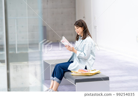 A young woman reading 99254035