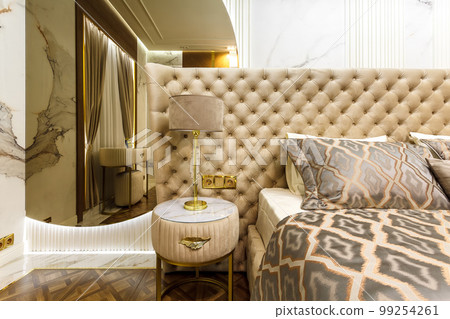 luxury hotel bedroom. Bed with carriage coupler headboard 99254261