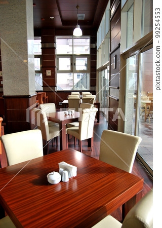 Ornate empty dining tables in a modern restaurant ready to serve 99254553