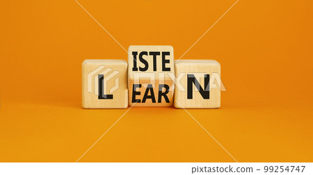 Listen and learn symbol. Concept word Listen Learn on wooden cubes. Beautiful orange table orange background. Business, education and listen and learn concept. Copy space. 99254747