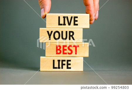 Live your best life symbol. Concept words Live your best life on wooden blocks. Beautiful grey table grey background. Businessman hand. Business live your best life concept. Copy space. 99254803