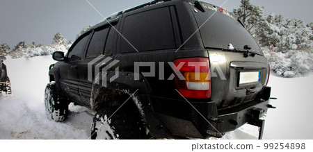 One SUV 4x4 cars go on snowy road, winter season 99254898