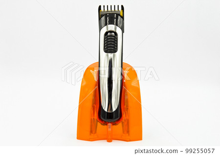 Cordless and chrome electric shaver charger, charged hair clipper isolated on white background 99255057
