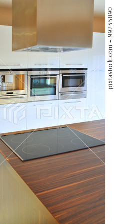 Interior of modern kitchen equipment, white and walnut cabinets Interior of modern kitchen equipment, white and walnut cabinets 99255090
