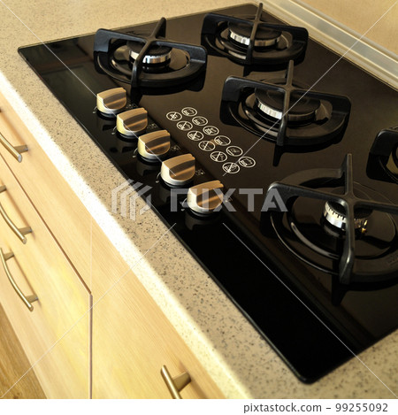 Modern kitchen and glass ceramic built-in gas oven detail Modern kitchen and glass ceramic built-in gas oven detail 99255092