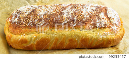 Fresh nutritious and golden colored bread homemade, isolated on beige paper Fresh nutritious and golden colored bread homemade, isolated on beige paper 99255457