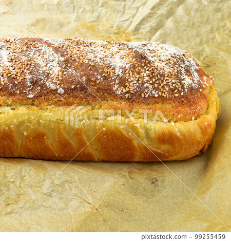 Fresh nutritious and golden colored bread homemade, isolated on beige paper Fresh nutritious and golden colored bread homemade, isolated on beige paper 99255459