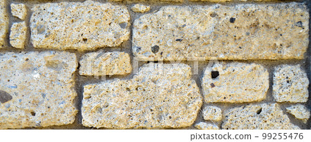 Sturdy yellow and beige cut stone wall, seamless lined up Sturdy yellow and beige cut stone wall, seamless lined up 99255476