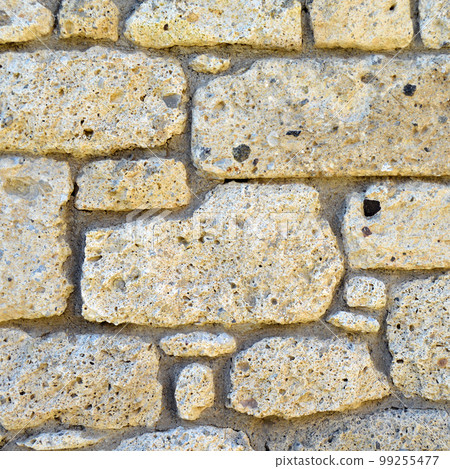 Sturdy yellow and beige cut stone wall, seamless lined up Sturdy yellow and beige cut stone wall, seamless lined up 99255477