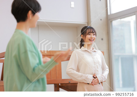 A young woman practicing vocalization while being taught by a voice trainer_6 99255716