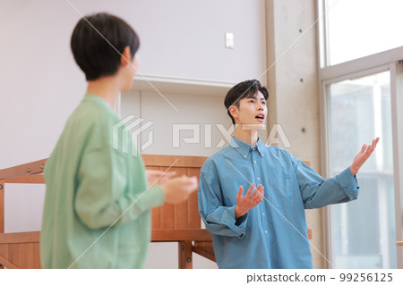 A man doing vocal training while being taught by a trainer_2 A man doing vocal training while being taught by a trainer_2 99256125
