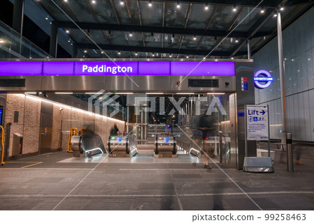 Entrance with Paddington text on purple metallic structure and empty escalators at underground subway station in London Entrance with Paddington text on purple metallic structure and empty escalators at underground subway station in London 99258463
