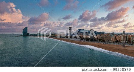 Panoramic aerial view of famous Barceloneta beach with hotel luxury W Barcelona. Birds eye of Barcelona, Catalunya, Spain. Panoramic aerial view of famous Barceloneta beach with hotel luxury W Barcelona. Birds eye of Barcelona, Catalunya, Spain. 99258579