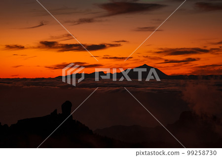 Spectacular sunset above the clouds of the Teide volcano national park on Tenerife. Sunset from the top of Gran Canaria Island. Pico de las Nieves. 99258730