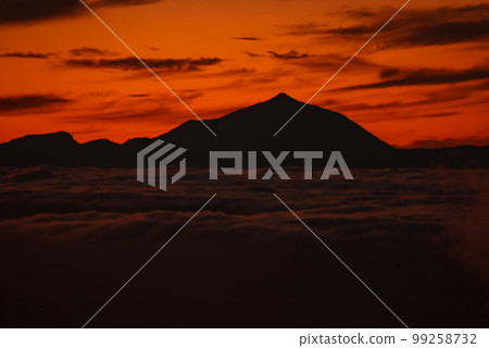 Spectacular sunset above the clouds of the Teide volcano national park on Tenerife. Sunset from the top of Gran Canaria Island. Pico de las Nieves. 99258732