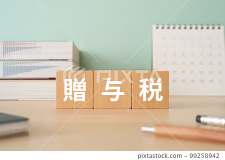 A desk with a block that says gift tax A desk with a block that says gift tax 99258942