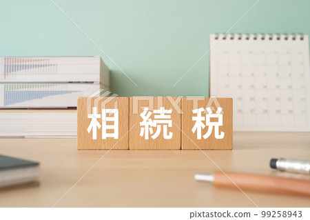 A desk with a block that says inheritance tax A desk with a block that says inheritance tax 99258943
