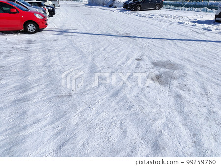 Parking lot with compacted snow Parking lot with compacted snow 99259760