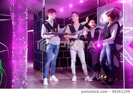 Cheerful laser tag players talking 99261209