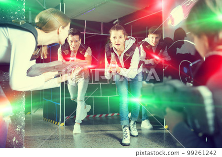 People in vests and with laser pistols playing emotionally laser People in vests and with laser pistols playing emotionally laser 99261242