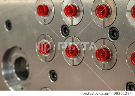 The close up scene of the red plastic screw cap from injection process. The close up scene of the red plastic screw cap from injection process. 99261284