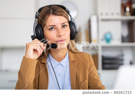 positive woman sitting with headphones in white room positive woman sitting with headphones in white room 99261725