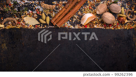 Different spices and herbs on a black background 99262396