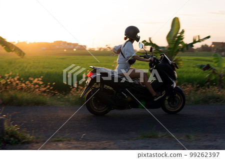 young girl on a motor scooter 99262397